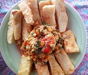Yams coated with egg and flour being served with mixed vegetables egg sauce