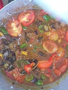 Photo of Tomatoes and beef being stirred into the soup Tomatoes and beef being stirred into the soup