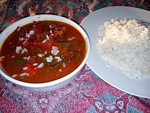Stuffed pepper soup being served with boiled rice