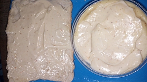Mayonnaise being plastered on bread