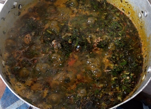Bitter leaf soup is simmering on a low heat