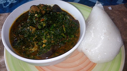Edikaikong soup is served with eba. Enjoy your meal!