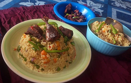 Serving of coconut rice with beef and fish