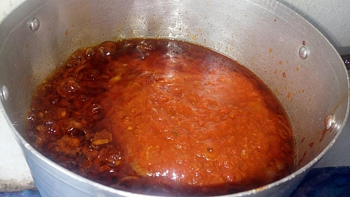 The boiled tomato is also added to the oil to cook
