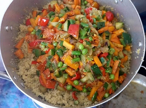 Stirring in steamed vegies into cooked couscous