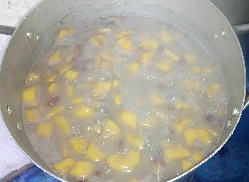 Once the beans is half cooked, add the diced plantain into it and cook until soft