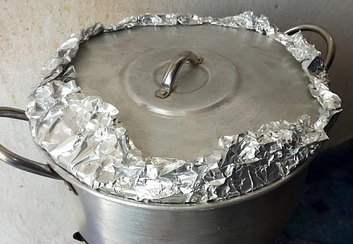 The foil paper help to trap in heat in the pot and hasten the cooking process without the rice turning soggy