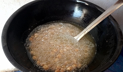Frying of peanut burger snack with oil