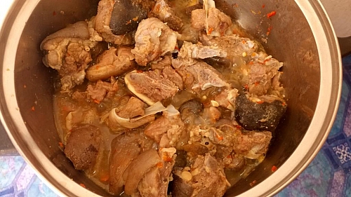 Boiling of goat meat for Asun