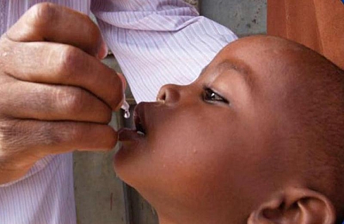 A child being given Oral Polio Vaccine as routine immunization for children as part of the Polio Eradication Initiative