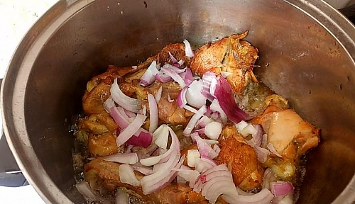 No need to remove the chicken from the oil, but just make sure you take out excess oil before you proceed