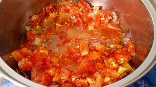 Once the onion is fragrant, add the diced tomatoes and fry until soft