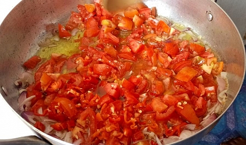Cook the tomatoes in the oil until the water dries up