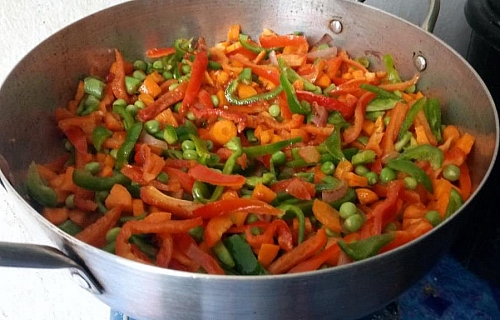 Add the bell peppers and the remaining vegetables and stir fry until they turn out soft, then season with the mentioned spices