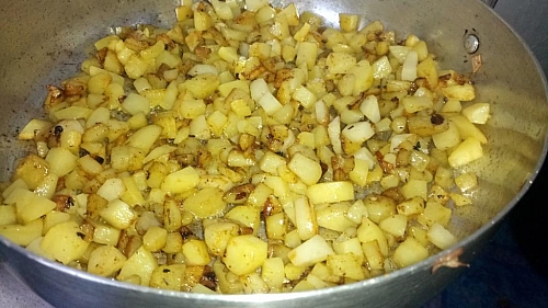 Fry the potatoes until they start to get brown, then flip to cook underneath