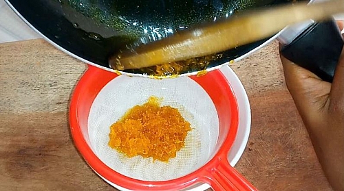 Strain out carrot oil from the solids once it has cool down