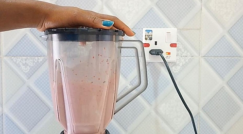 Making of strawberry milkshake in a blender