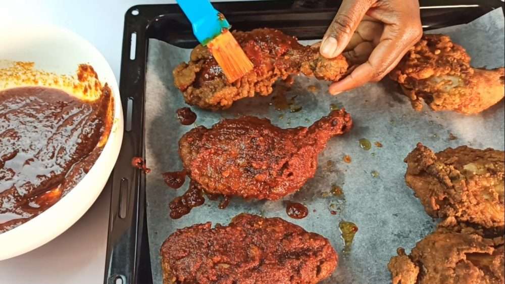 Coat the fried chicken with the Nashville hot sauce